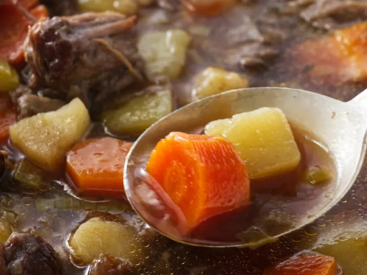 A spoonful of oxtail and vegetable soup.