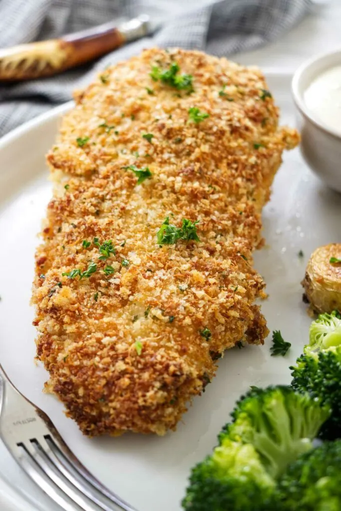 A chicken breast covered in panko breadcrumbs.