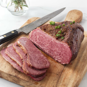 Slicing the corned beef on a cutting board.