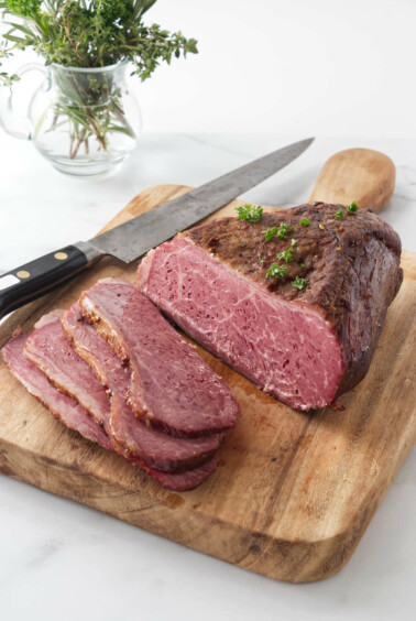 Slicing the corned beef on a cutting board.