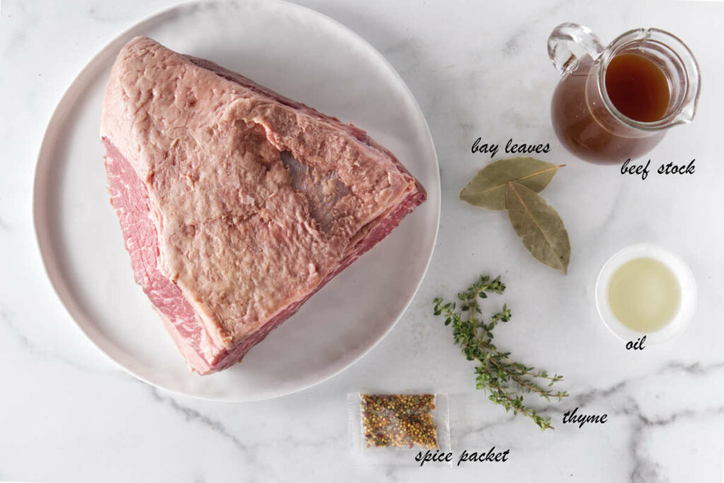 Corned beef, bay leaves, beef broth, oil, thyme, pickling spices from the corned beef package.