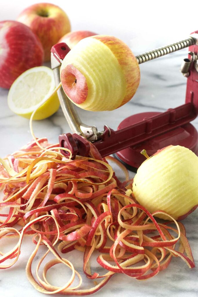 Using an apple peeler-corer-slicer to peel apples.