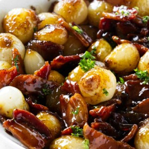 A serving dish with caramelized brown sugar pearl onions.