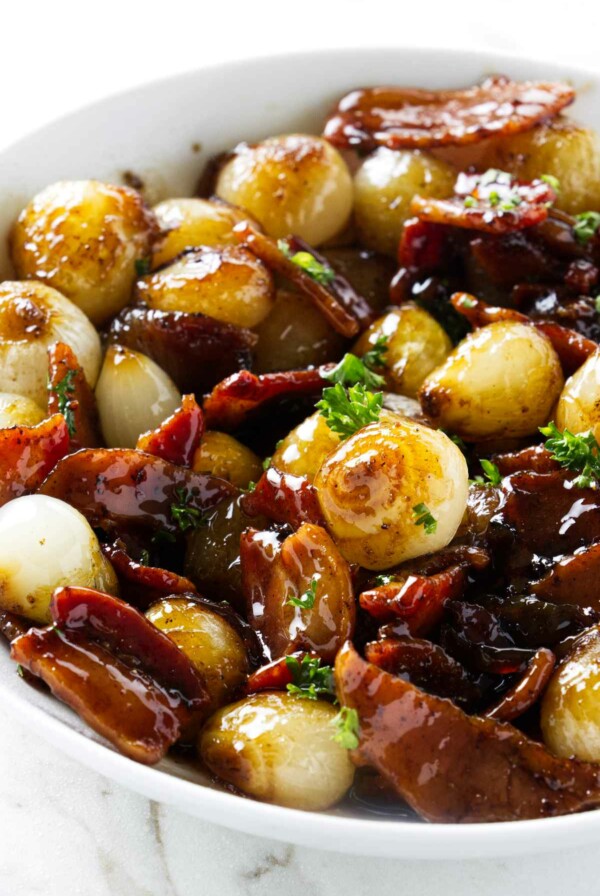 A serving dish with caramelized brown sugar pearl onions.