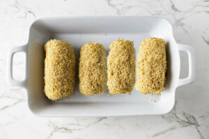 Chicken cordon blue in a baking dish ready for the oven.