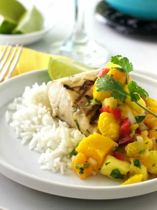 A plate with rice, grilled Mahi Mahi, and mango salsa.