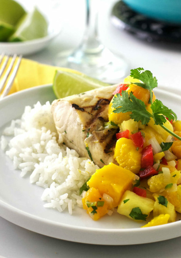 A plate with rice, grilled Mahi Mahi, and mango salsa.