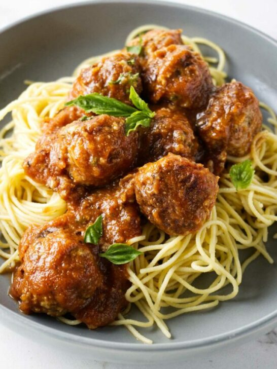 Turkey meatballs in a bowl with spaghetti noodles.