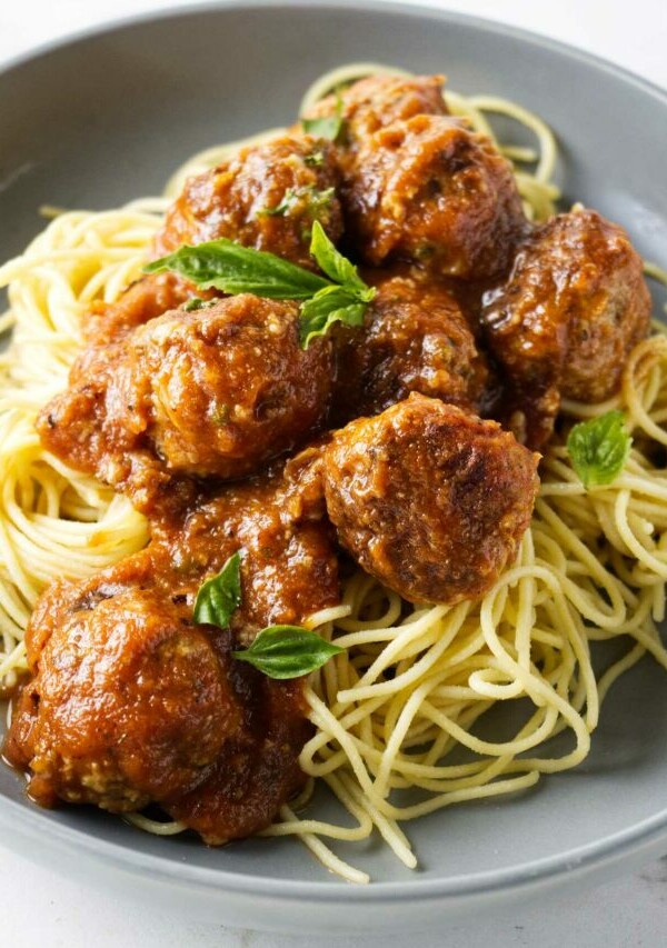 Turkey meatballs in a bowl with spaghetti noodles.