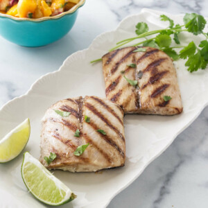Grilled Mahi Mahi fillets with lime, cilantro, and mango salsa.