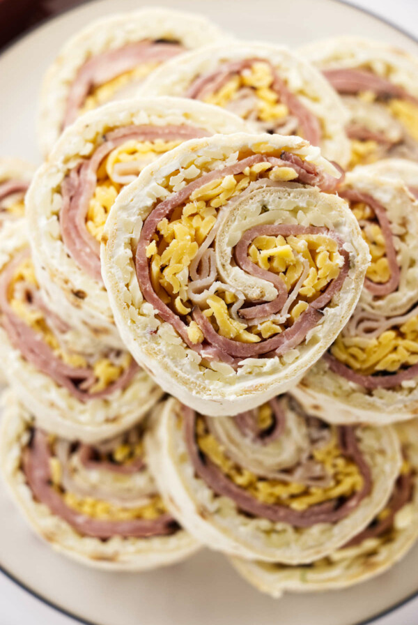 Ham and turkey pinwheel sandwiches with cheese.