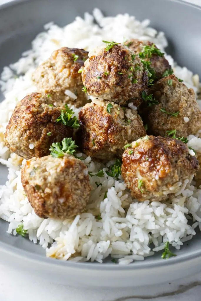 Turkey meatballs in a bowl with white rice.