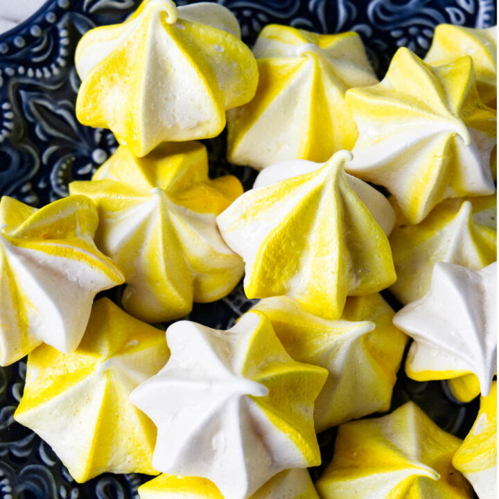 Lemon meringue cookies on a blue plate.