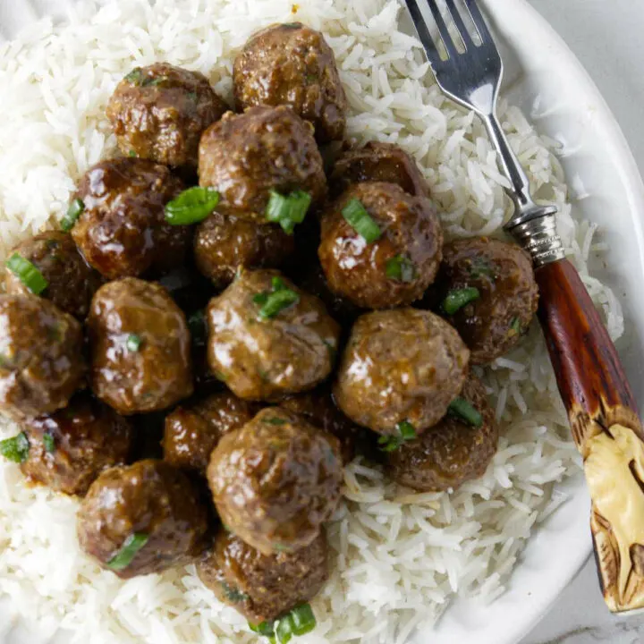 Wagyu meatballs on a plate with white rice.