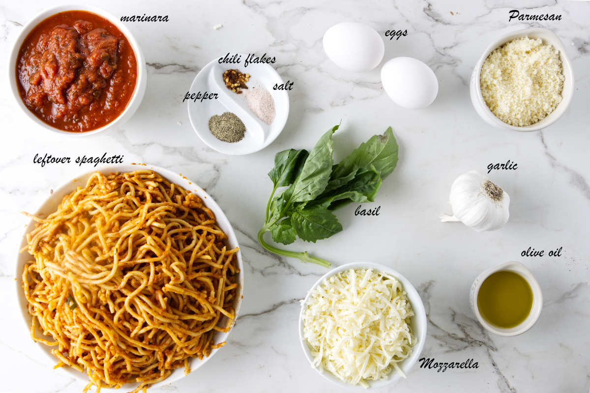 Spaghetti, marinara, salt, pepper, chili flakes, eggs, parmesan cheese, garlic, olive oil, mozzarella, and basil.