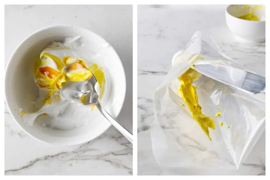 Mixing yellow food coloring in a bowl of meringue then adding some to a piping bag.