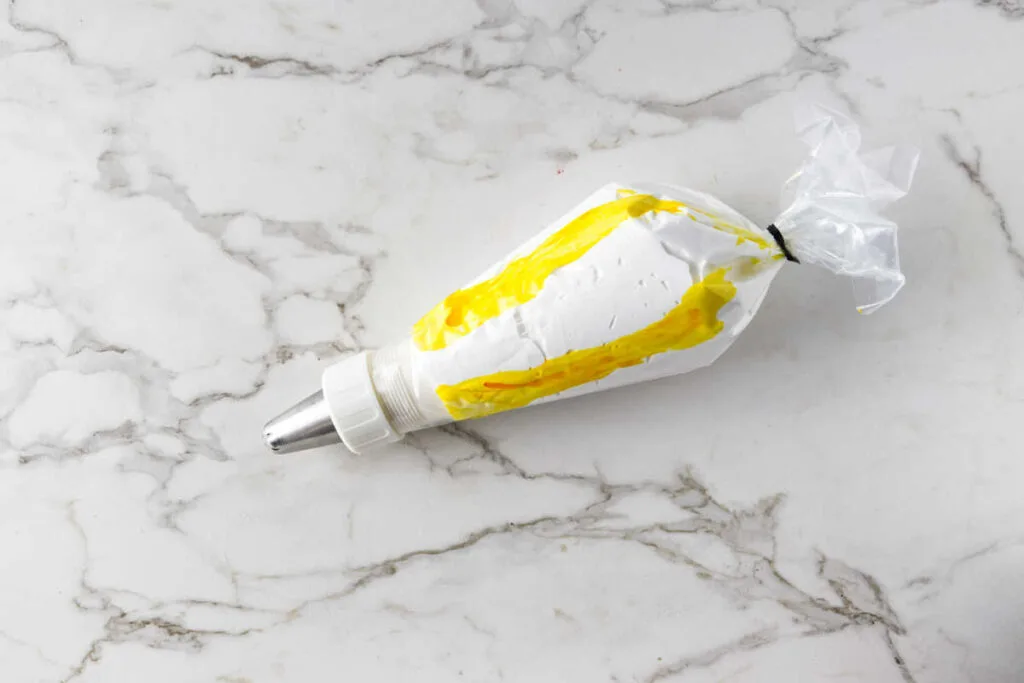 Yellow and white meringue in a piping bag.