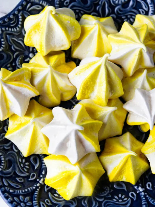 Several lemon meringue cookies on a plate.