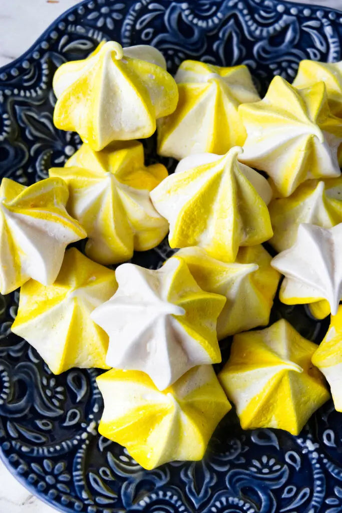 Several lemon meringue cookies on a plate.