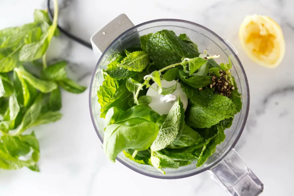 Fresh herbs in a food processor.