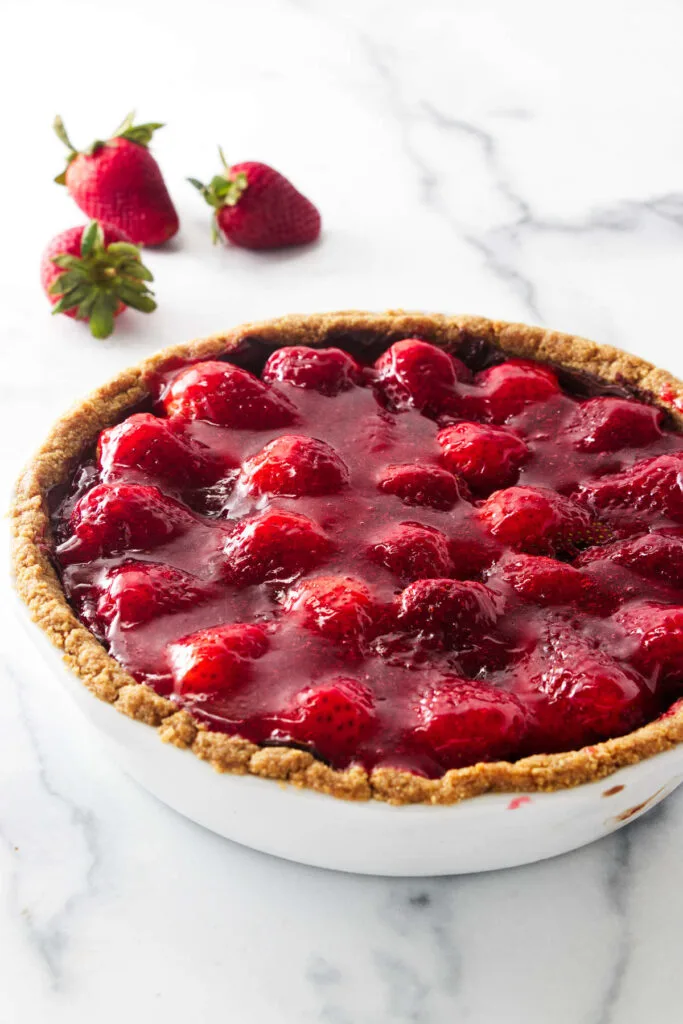 baking dish with a cookie crust filled with glazed berries.