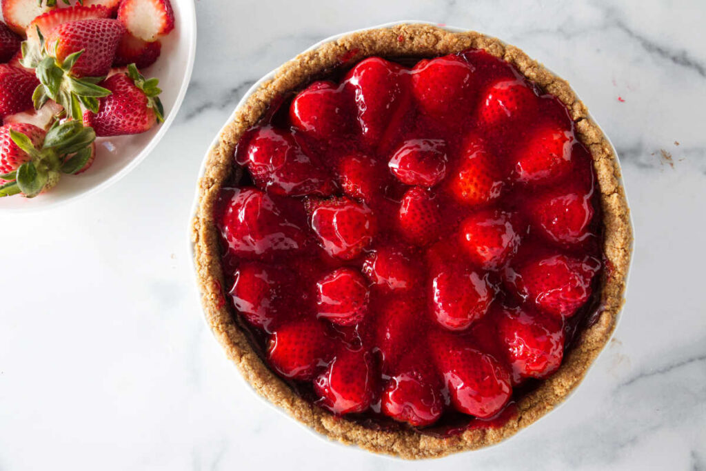 A fresh strawberry pie in a graham cracker crust.