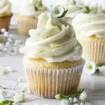 White chocolate cupcakes decorated with small white flowers.