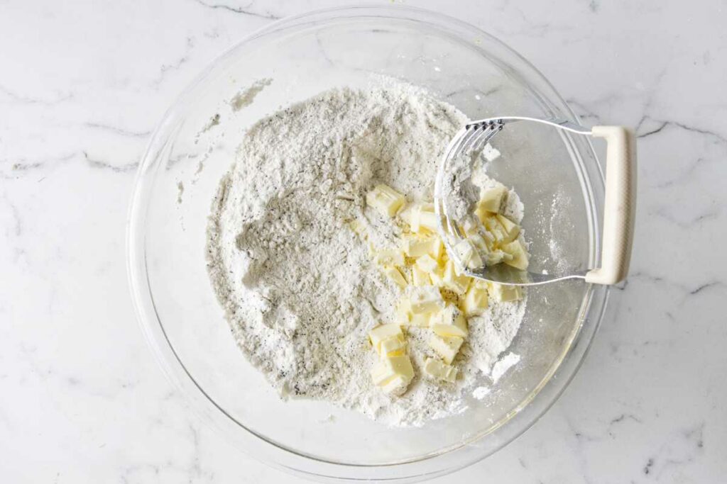 Blending cold butter into flour mixture for scones.