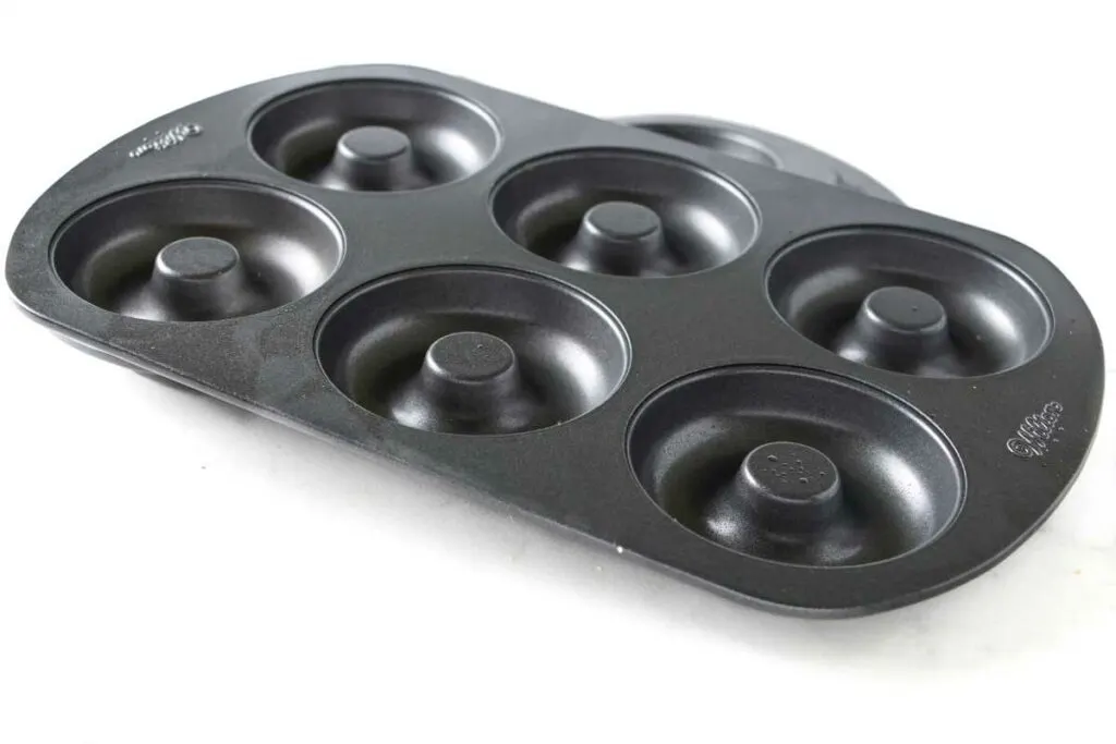 Two donut pans with six cavities each.