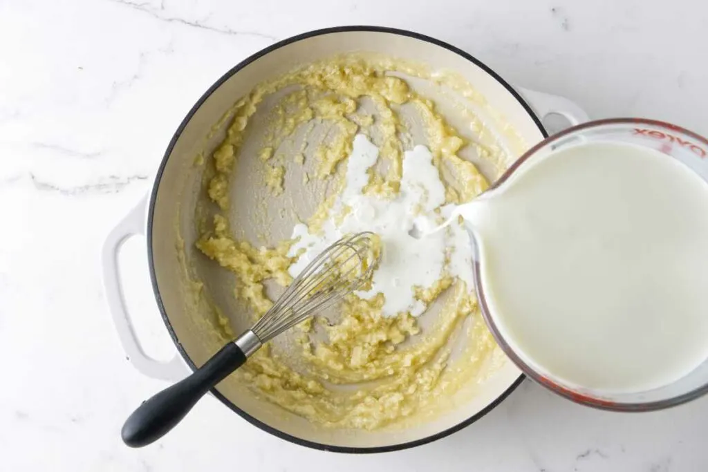 Making bechamel sauce in a large saucepan.