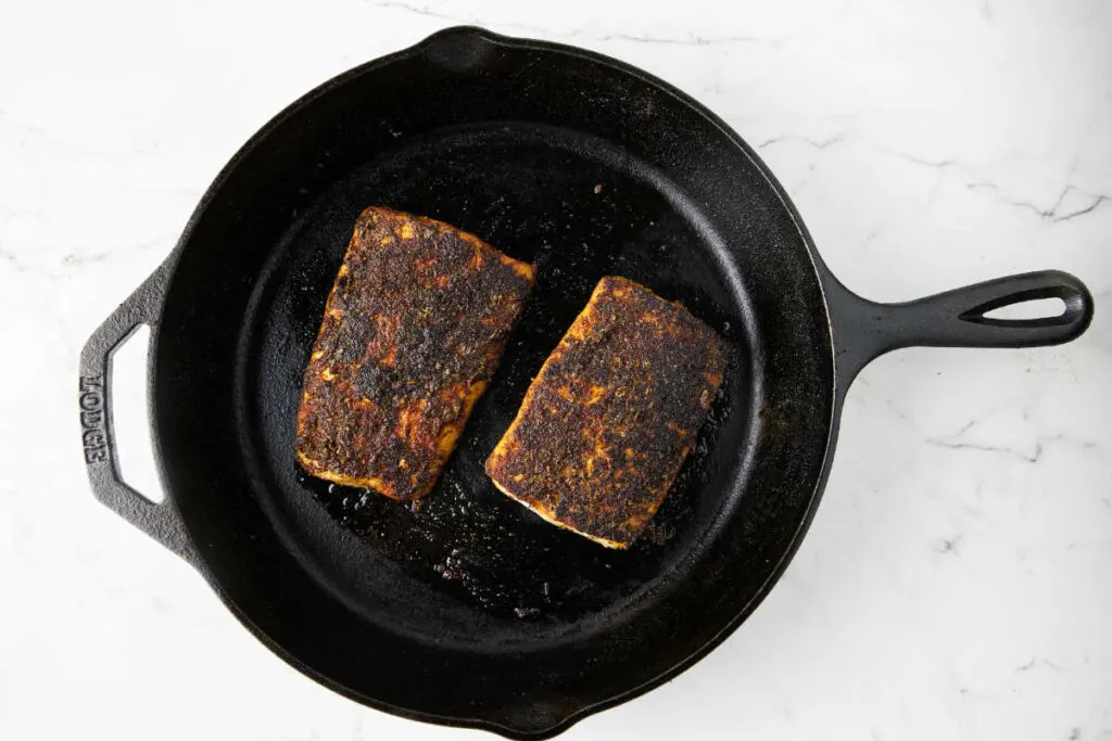 Searing mahi mahi in a cast iron skillet.