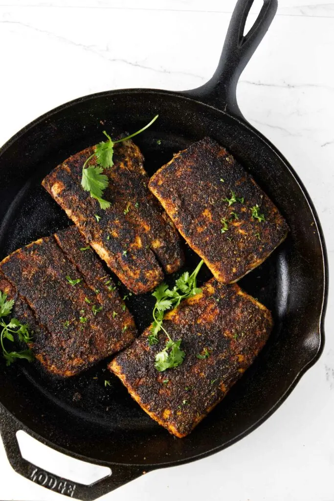 Four filets of mahi mahi in a skillet.