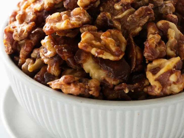 a bowl of brown sugar candied walnuts.