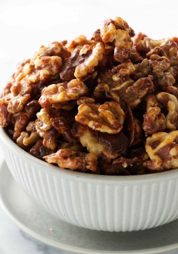 a bowl of brown sugar candied walnuts.