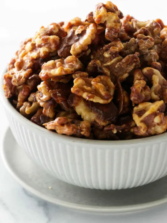 a bowl of brown sugar candied walnuts.