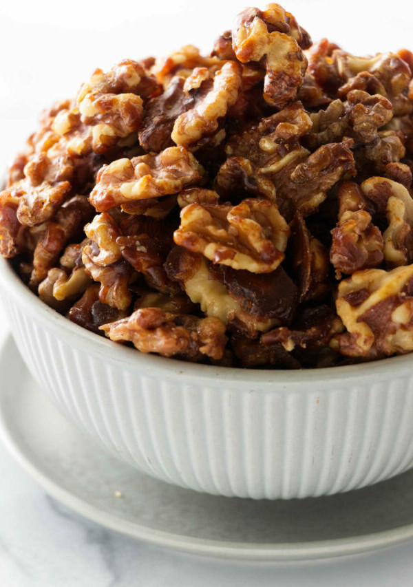 a bowl of brown sugar candied walnuts.