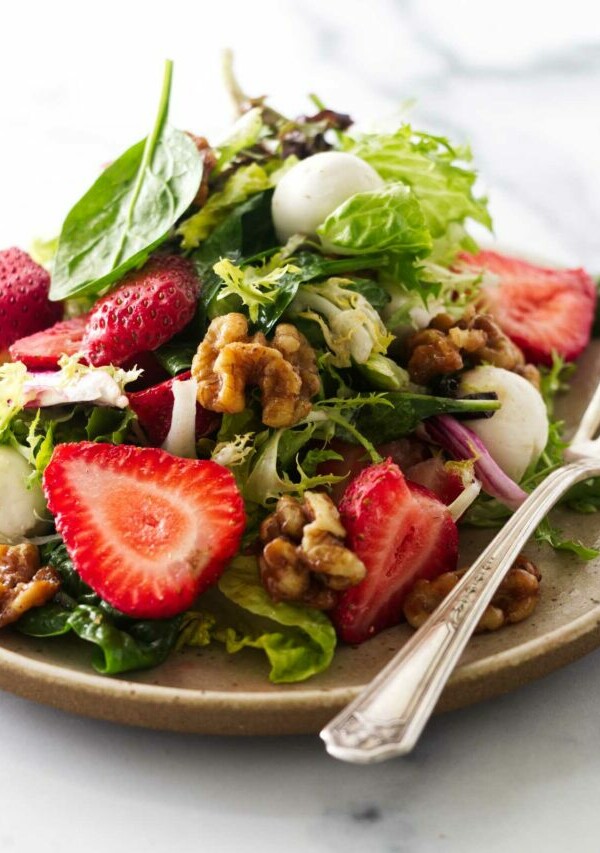 Close view of a serving of strawberry walnut salad.