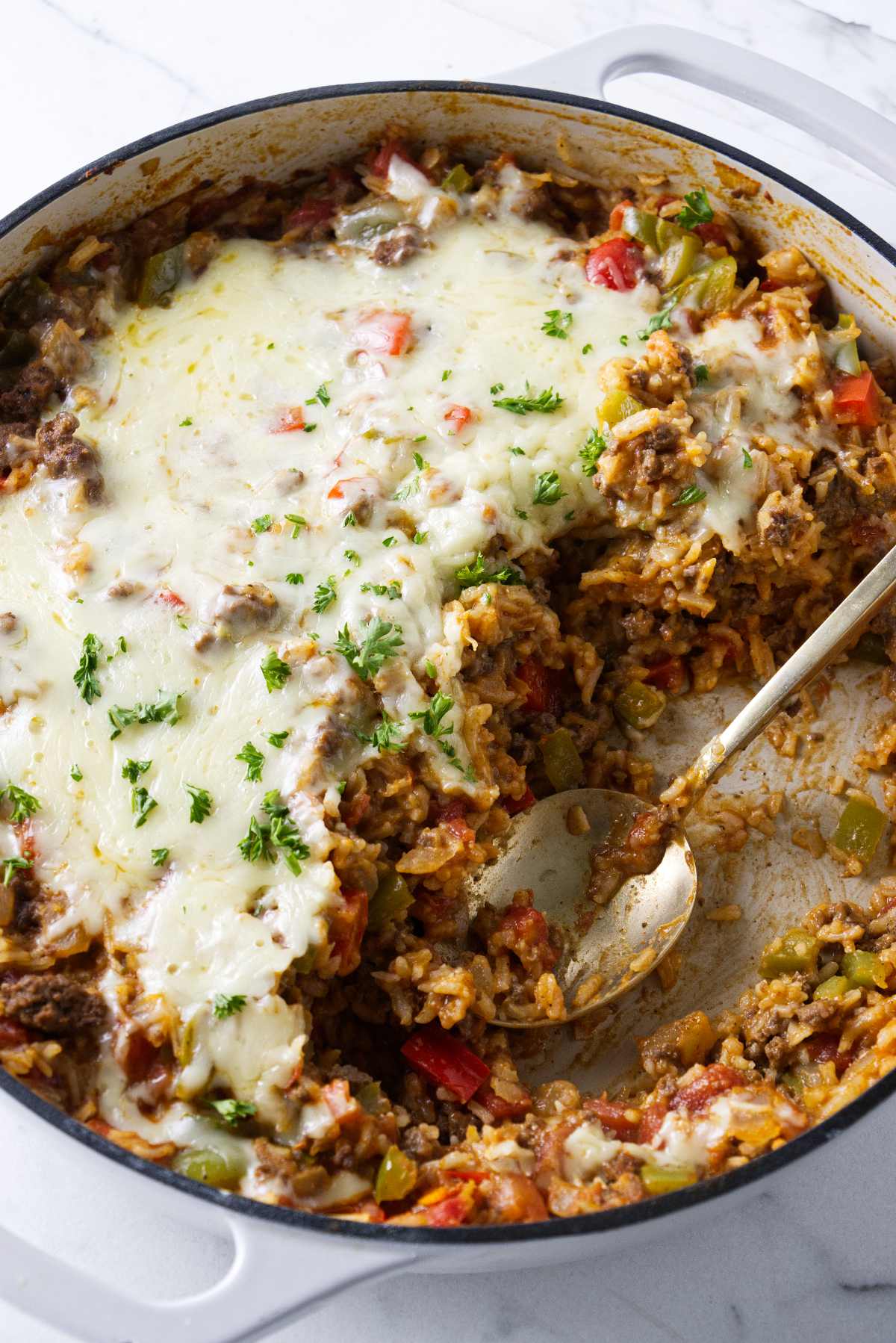 A skillet casserole with ground beef, bell peppers, and rice.