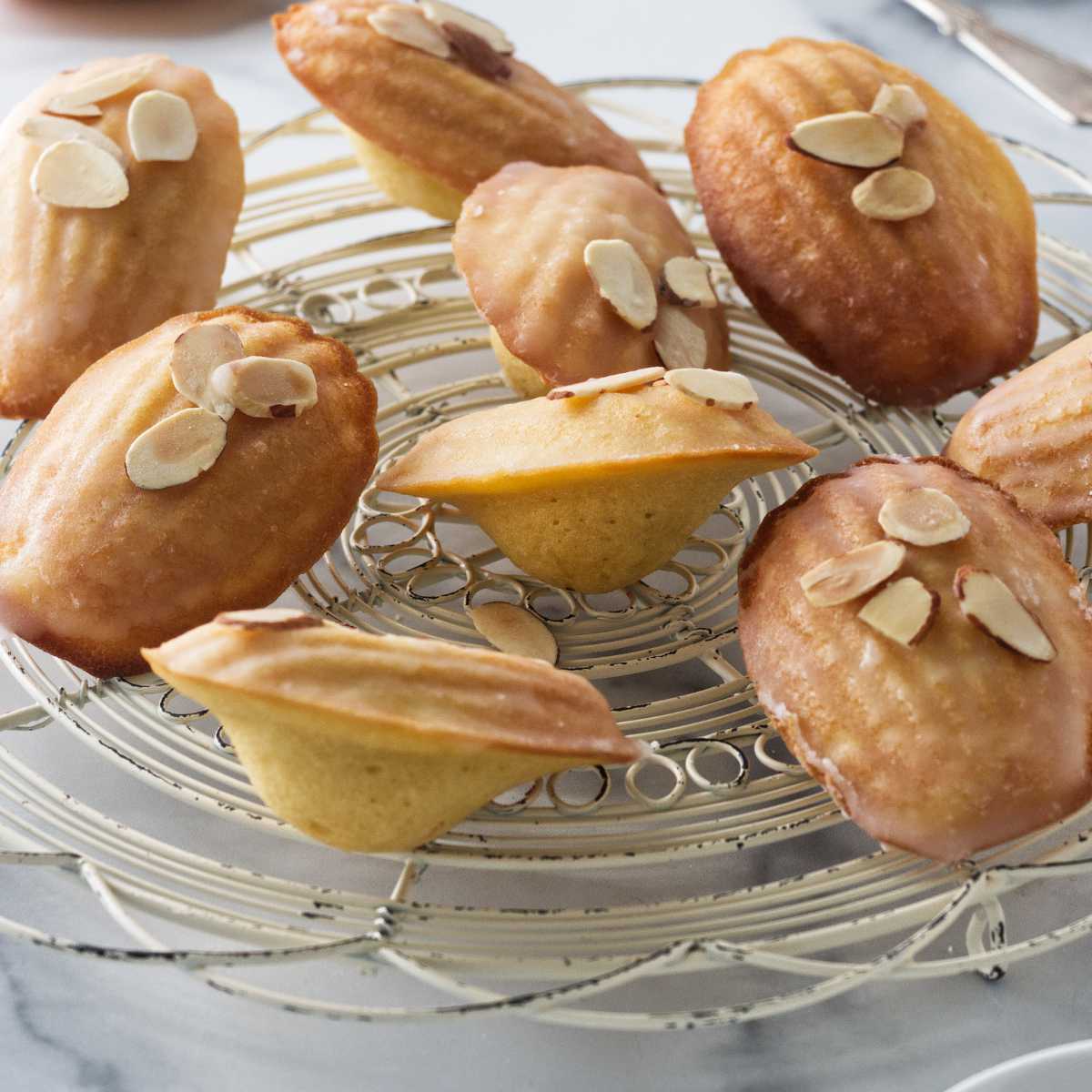 Almond madeleines on a cooling rack.