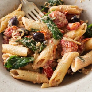 close up of a serving of baked goat cheese pasta.