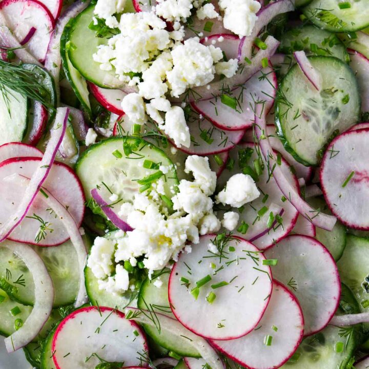 A serving of cucumber radish salad with herbs and feta cheese.