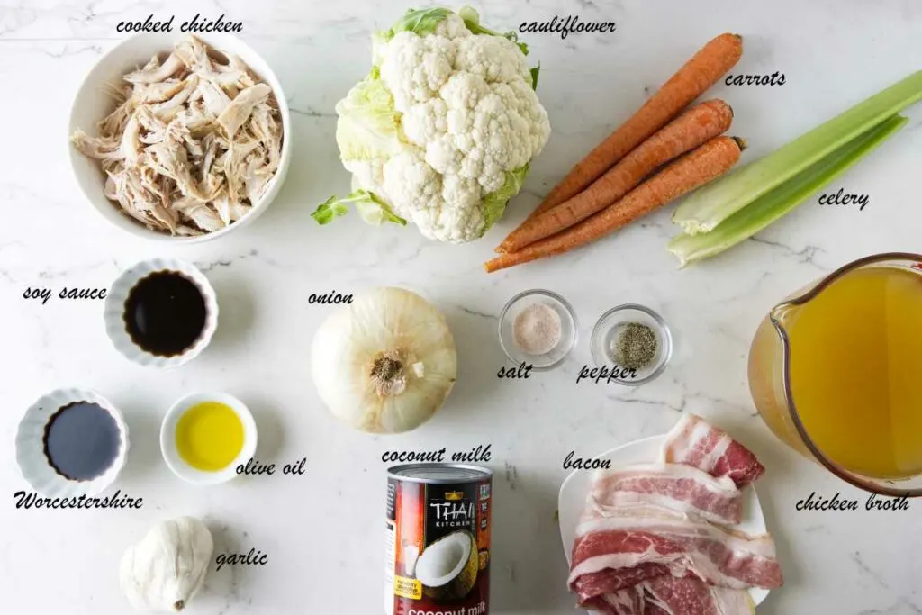 Ingredients for soup: cauliflower, carrots, celery, onion, salt, pepper, chicken broth, bacon, coconut milk, garlic, olive oil, soy sauce, Worcestershire, and chicken.