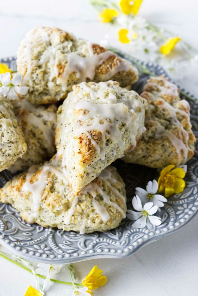 A stack of poppy seed scones on a plate.