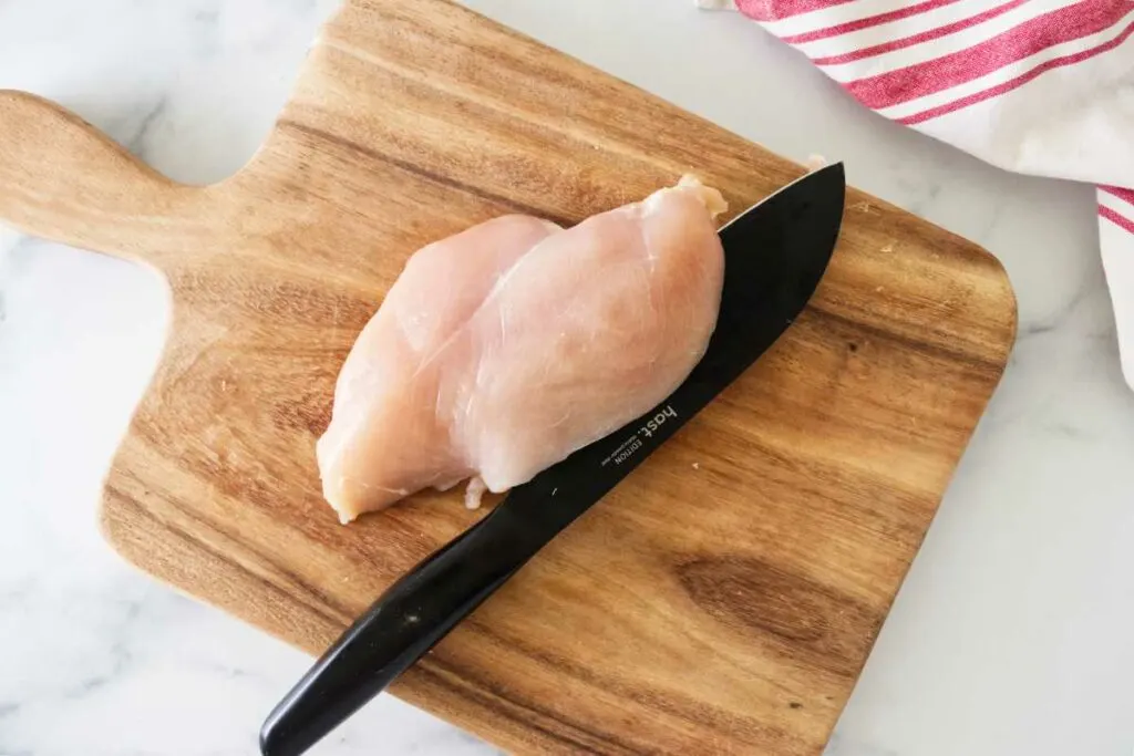 Splitting a chicken breast in half.
