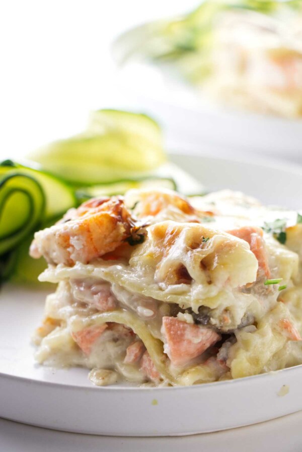 A slice of seafood lasagna on a dinner plate.
