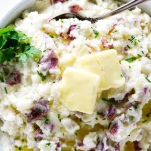 A bowl with mashed red potatoes.