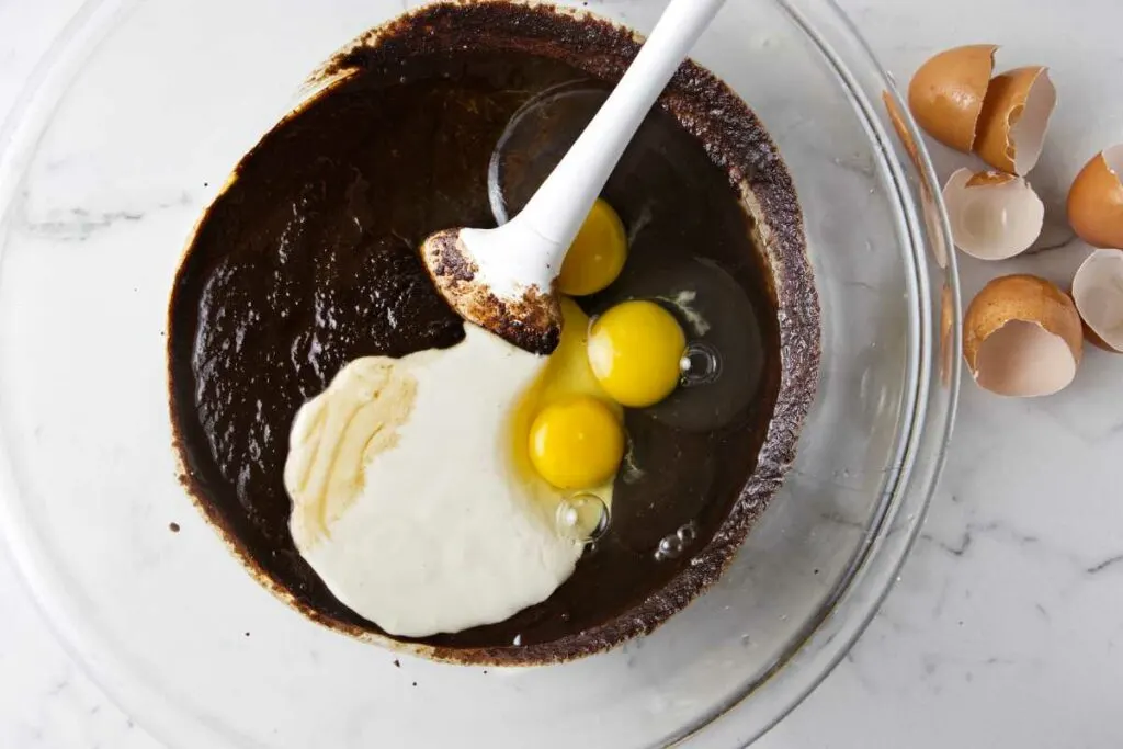 Mixing sourdough starter into brownie batter.