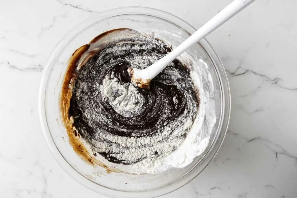 Stirring the flour mixture into the sourdough discard brownie batter.