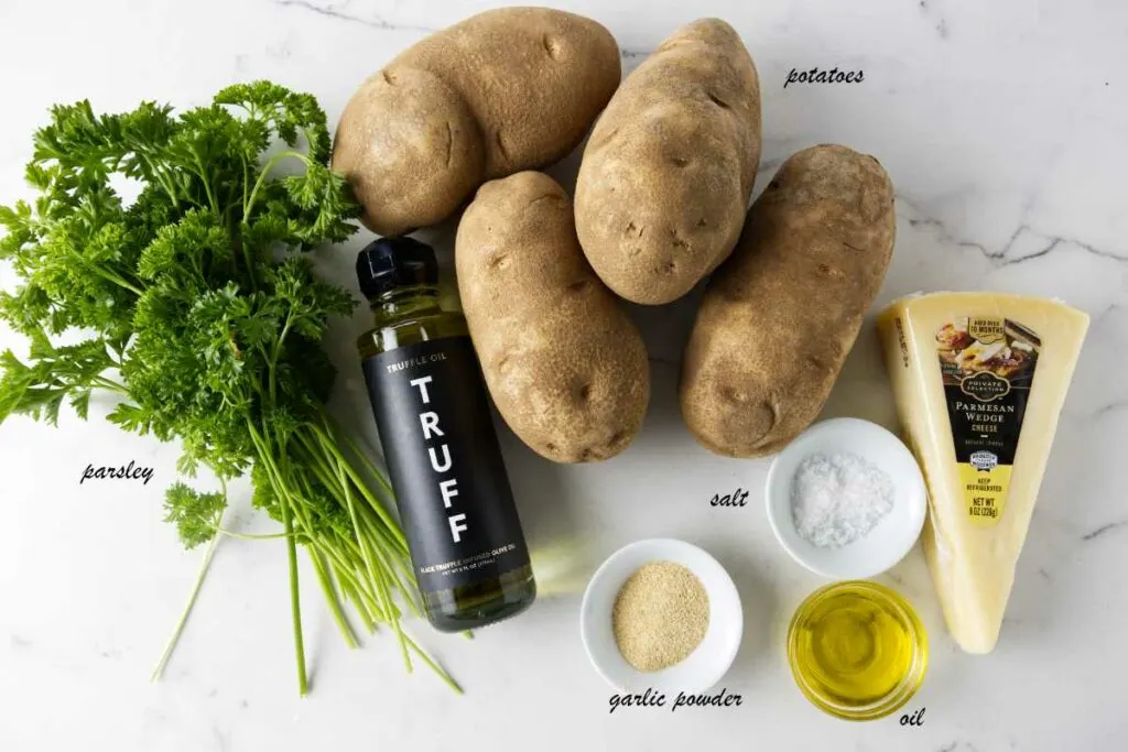 Ingredients for truffle fries: potatoes, parmesan cheese, oil, salt, garlic, truffle oil, parsley.
