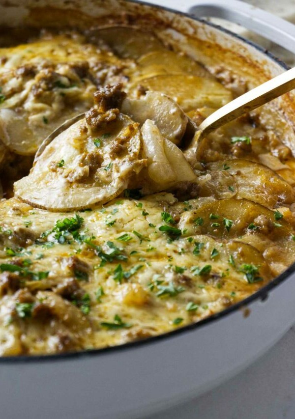 Scooping a serving of hamburger potato skillet bake.